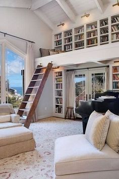 a living room filled with lots of furniture and a book shelf next to a window