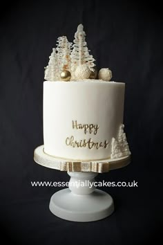 a white christmas cake with gold decorations on top