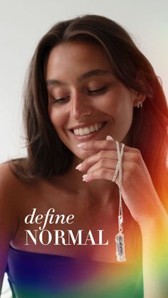 Woman holding a silver pendant with a crystal quartz.