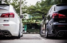 two black and white cars parked next to each other