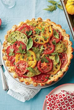 a pie with tomatoes and other vegetables on it