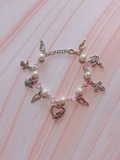 The bracelet is about 6 inches long with an adjustable lobster claw closure. If a different size or extender is needed please feel free to message me (: Bracelet Coquette, Angel Cupid, Pink Y2k, Diy Bracelet Designs, Bracelet Beaded, Cross Charms, Pink Bracelet, Diy Bracelet, Austin Tx