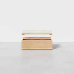 an empty wooden box on a white surface