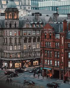 an image of a city street with cars and buildings