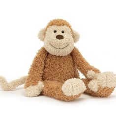 a stuffed monkey is sitting on the floor