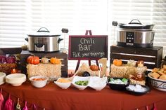 a table topped with lots of food next to a sign