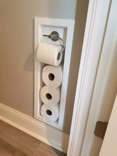 two rolls of toilet paper are hanging on the wall