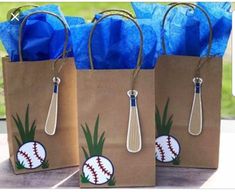 three brown paper bags with baseball designs on them