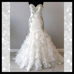 a white wedding dress is displayed on a mannequin