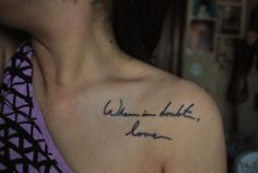 a woman with a tattoo on her shoulder that says, when in doubt i love you