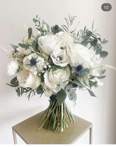 a bouquet of white flowers sitting on top of a table