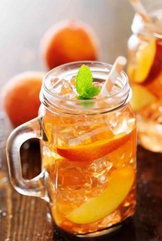 a mason jar filled with iced tea and sliced apples