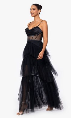 Here's a long black tiered prom dress that is sure to wow the crowd. With a sheer corset-style waist, this long black evening gown offers a sexy vibe for prom, galas, and other red-carpet events. A pleated cowl neckline tops this long black evening gown, while the long a-line skirt flows in tiered ruffles down to the floor to finish the design. Fun, fancy, and feminine, this long black tiered prom dress is a unique style from Betsy and Adam. Corset Layering, All White Party Dresses, Ethereal Design, Cape Collar, Tiered Prom Dress, Missy Dresses, Neutral Dresses, Bachelorette Party Dress, Shimmery Dress