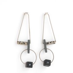 Silver, Steel & Stone Earrings - These dramatic earrings feature stainless steel triangles swinging from sterling silver tubing, each holding a twisted steel hoop with a black acrylic cube adorned with cubic zirconia stones. They effortlessly dangle from sterling silver posts, adding a bold touch to any look. Dramatic Earrings, Artful Home, Black Acrylic, Black Acrylics, Stone Earrings, Triangles, Silver Earrings, Cubic Zirconia, Original Art