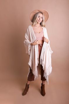 Looking for a stylish and fun way to stay warm this winter? Check out our Open Work Frayed Bohemian Ruana! This cute and cozy wrap is perfect for chilly days and nights, and can be dressed up or down to suit any occasion! #lovemyleto 100% Acrylic Imported Casual One Size Fringe Shawl, Bohemian Knit Poncho With Fringe, Casual One-size Shawl With Fringe, Cozy Outerwear For Cold Weather One Size, Cozy One-size Outerwear For Cold Weather, Bohemian Knit Shawl, Bohemian Shawl For Fall Layering, Bohemian Knit Shawl One Size, Bohemian One-size Knit Shawl