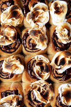 there are many rolls with chocolate icing on them