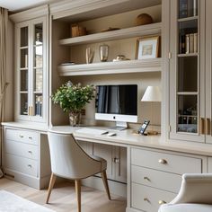 a home office with built - in desk, chairs and bookshelves is shown