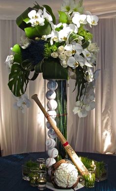 a vase filled with white flowers and baseball bats