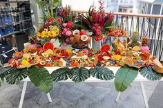 a table topped with lots of different types of foods and flowers on top of it