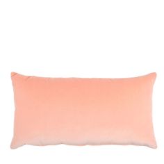 an orange pillow on a white background with a light pink back ground and the bottom half of it