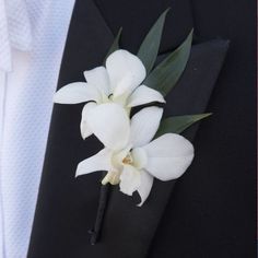 a white flower corsage on a black suit