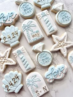 decorated cookies are arranged on a marble countertop with the words, date and time