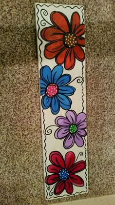 an image of a flower sticker on the ground with it's border painted red, blue, and purple