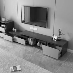 a living room with grey walls and white furniture in front of a flat screen tv