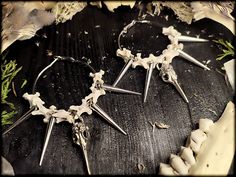 Uniquely crafted bone hoop earrings with spikes. The earrings are relatively heavy for their size due to the pendant! The bones and spikes provide a slight rattle in the ear! This is handmade jewelry from real animal bones that I process into individual jewelry! Each bone is an absolutely unique piece, so slight deviations are possible! I would be happy to wrap your order as a gift! Please select the gift packaging in the ordering process ;)) Creole diameter 5cm: Width about 6cm Length approx. 9 Gothic Spiked Jewelry For Halloween, Gothic Halloween Jewelry With Spikes, Gothic Jewelry With Spikes For Alternative Fashion, Handmade Edgy Earrings For Festivals, Earrings Gothic, Witch Earrings, Bone Crafts, Bone Earrings, Jewelry Gothic