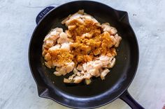 some food is cooking in a skillet on the counter top and ready to be eaten