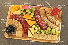 a wooden tray filled with different types of cheese and crackers