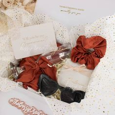 an open gift box filled with different types of hair accessories and personalized cards for someone's special occasion