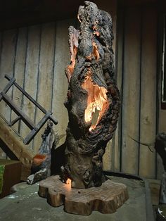 a large piece of wood that has been turned into a fire pit with flames coming out of it