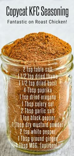 a glass jar filled with spices on top of a table