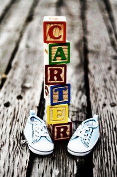 a pair of white shoes sitting next to blocks spelling out the word care on top of them