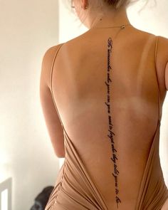 the back of a woman's body is shown with writing on her left side