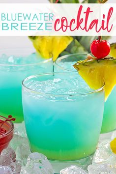 the blue water cocktail is garnished with pineapples and cherries on top