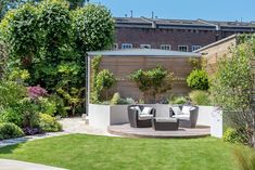 an outdoor seating area in the middle of a garden