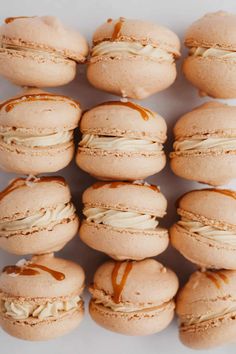 several macaroons with frosting and caramel drizzled on them