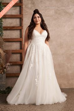 a woman in a white wedding dress posing for the camera