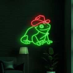 a neon sign with a frog wearing a cowboy hat