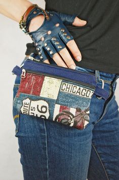 a person wearing blue leather gloves and holding a purse with the word chicago printed on it