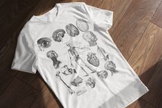 Unisex jersey short sleeve tee This Vintage Anatomy Illustration T-Shirt is the perfect gift for healthcare professionals, medical students, doctors, and nurses. Featuring intricate anatomical illustrations, this tee brings a unique blend of education and style. Made from soft, high-quality fabric, this unisex t-shirt is ideal for those passionate about medicine and the human body. Whether you're looking for a thoughtful gift or a stylish piece for your own wardrobe, this medical-themed t-shirt Professional Gifts, Medical Professionals, Healthcare Professionals, Leisure Wear, Jersey Shorts, Anatomy, Health Care, Quality Fabric, Short Sleeve Tee