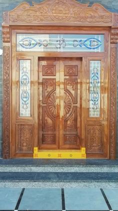 an ornate wooden door on the side of a building