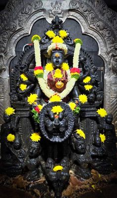 the statue is decorated with yellow flowers