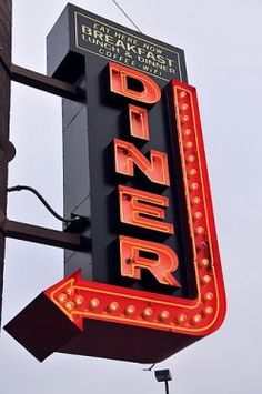 a neon sign that reads dinner on the side of a building