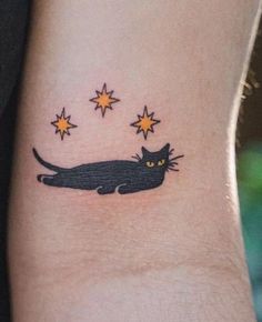 a black cat with yellow eyes and stars on it's back side ribcage