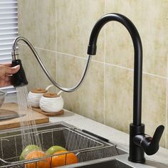 a kitchen sink with a faucet running water from it's spout