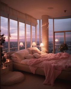 a bedroom with large windows and a pink blanket on the bed in front of it