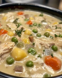 a bowl filled with soup and vegetables on top of a table